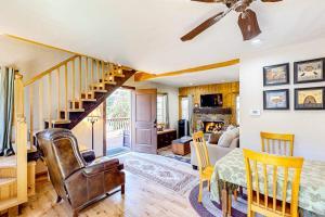 a living room with a staircase and a living room with a table at Heliotrope Hideaway in Lake Arrowhead