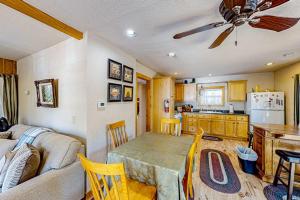 a living room with a table and a kitchen at Heliotrope Hideaway in Lake Arrowhead