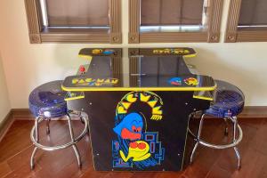 a ping pong table with two chairs in a room at The Chateau in Lake Arrowhead +37 photos