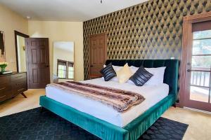 a large bedroom with a large bed and a mirror at The Chateau in Lake Arrowhead