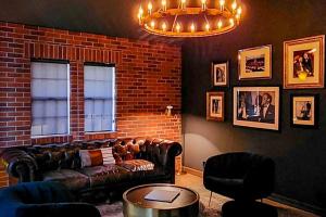 a living room with a couch and a brick wall at The Chateau in Lake Arrowhead