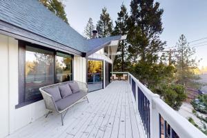 a porch with a chair on a house at The Snow White in Lake Arrowhead