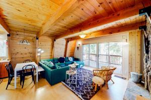 a living room with a green couch and a table at Hidden Wonder in Crestline