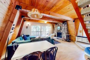 a living room with a table and chairs and a fireplace at Hidden Wonder in Crestline