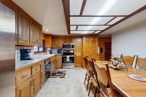 a kitchen with wooden cabinets and a table with chairs at Sugar Pine Retreat in Twin Peaks +21 photos