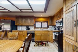 a kitchen with wooden cabinets and a wooden table at Sugar Pine Retreat in Twin Peaks