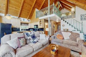 a living room with a couch and a table at Cedar Glen Hideaway in Lake Arrowhead