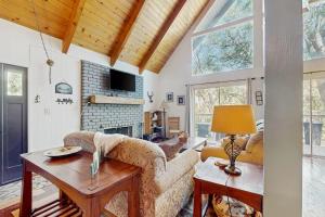 a living room with a couch and a table at Cedar Glen Hideaway in Lake Arrowhead
