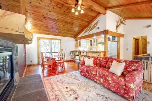 a living room with a red couch and a table at Sky High Cabin in Crestline
