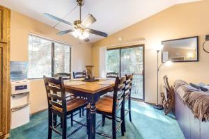 a dining room with a table and chairs and a bed at Morrison Manor in Lake Arrowhead