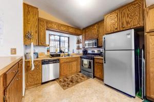 a kitchen with wooden cabinets and a white refrigerator at Morrison Manor in Lake Arrowhead