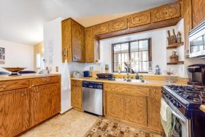 a kitchen with wooden cabinets and a sink and a stove at Morrison Manor in Lake Arrowhead +12 photos