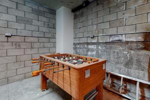 a wooden foosball table in front of a brick wall at Running Springs R-n-R in Running Springs