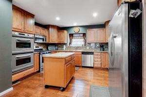 a kitchen with wooden cabinets and stainless steel appliances at Running Springs R-n-R in Running Springs