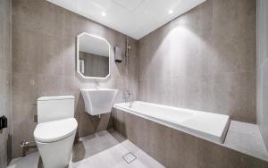 a bathroom with a toilet and a tub and a sink at d hotel in Seoul +18 photos