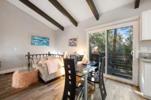 a living room with a table and a couch at Moonstar Lodge in Lake Arrowhead +22 photos