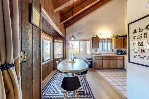 a kitchen with a table in the middle of a room at Grey Stone Fire in Running Springs