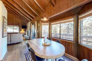 a dining room with a wooden table and chairs at Grey Stone Fire in Running Springs
