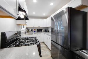 a kitchen with a stove and a black refrigerator at Moonstar Lodge in Lake Arrowhead