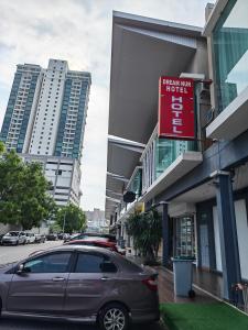 a car parked in front of a building with a sign at Hotel Dream Nur Kota Syahbandar in Malacca +17 photos