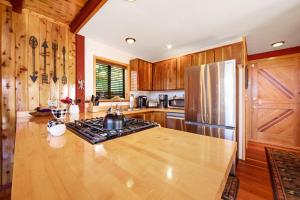a kitchen with a stove and a refrigerator at The Valley's Cabin in Green Valley Lake