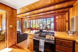 a kitchen with a stove top oven in a room at The Valley's Cabin in Green Valley Lake