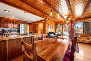 a kitchen with a large wooden table in a room at The Valley's Cabin in Green Valley Lake