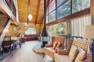 a living room with a couch and a fireplace in a house at Retro Cabin in Lake Arrowhead