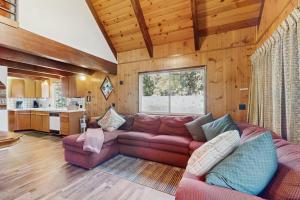 a living room with a couch and a kitchen at Retro Cabin in Lake Arrowhead