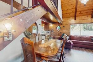 a dining room with a table and a couch at Retro Cabin in Lake Arrowhead +20 photos