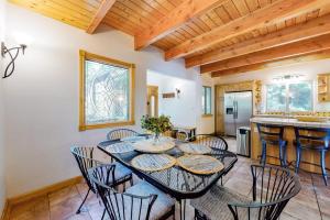 a dining room with a table and chairs and a kitchen at Million Dollar Mountain View in Crestline