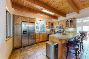a kitchen with wooden cabinets and a stainless steel refrigerator at Million Dollar Mountain View in Crestline