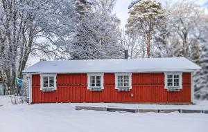 a red house with snow on top of it at Amazing Home In Sävsjö With Kitchen in Sävsjö +18 photos