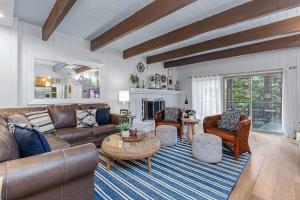 a living room with a couch and chairs and a fireplace at Serene Cabin in Lake Arrowhead +51 photos