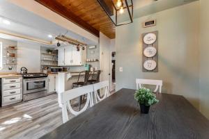 a kitchen and dining room with a table and clocks on the wall at Blue Bird Beauty in Running Springs