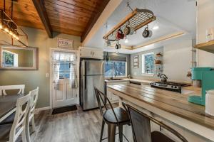 a kitchen with a wooden counter top and a kitchen island at Blue Bird Beauty in Running Springs +18 photos