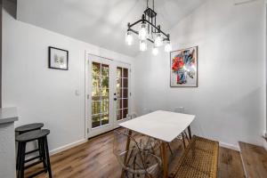 a dining room with a white table and chairs at Red Cottage Charmer in Lake Arrowhead