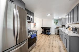 a kitchen with stainless steel appliances and wooden floors at Red Cottage Charmer in Lake Arrowhead