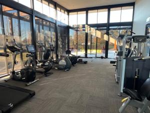 a gym with treadmills and elliptical machines at PONZ Lake Retreat - Nagambie in Nagambie