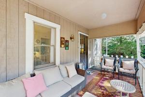 a living room with a couch and a table at The Cottage in Lake Arrowhead