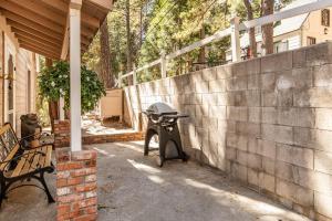 a motorcycle parked next to a wall next to a bench at The Cottage in Lake Arrowhead