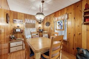 a dining room with a wooden table and chairs at The Cottage in Lake Arrowhead