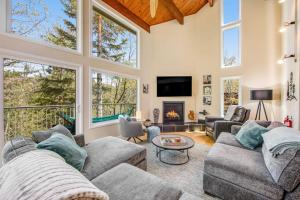 a living room with two couches and a fireplace at Timber Top Retreat in Lake Arrowhead