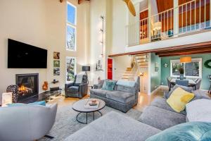 a living room with a couch and a fireplace at Timber Top Retreat in Lake Arrowhead