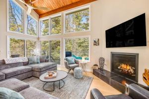 a living room with a couch and a fireplace at Timber Top Retreat in Lake Arrowhead
