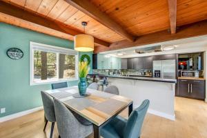 a dining room with a table and chairs in a kitchen at Timber Top Retreat in Lake Arrowhead +25 photos