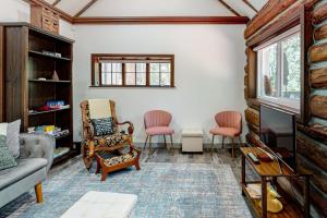 a living room with a couch and two chairs at Top Town Retreat in Crestline