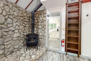 a stone wall in a room with a fireplace at Top Town Retreat in Crestline