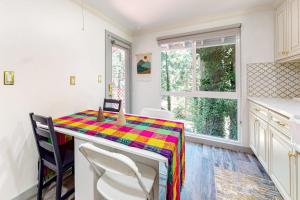 a kitchen with a table with a colorful table cloth at Top Town Retreat in Crestline