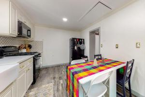 a kitchen with a table with a colorful cloth on it at Top Town Retreat in Crestline